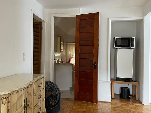 Living room, facing bathroom, mini fridge and microwave