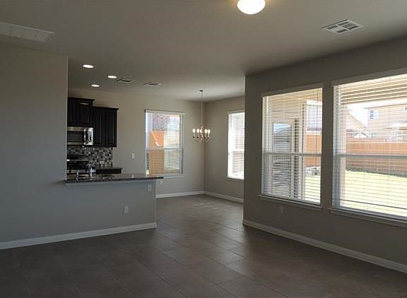 View of breakfast area and kitchen from the front door. Hard