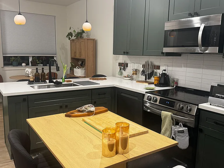 Updated kitchen with ample cabinetry, generous counters, and stainless steel appliances plus a convenient breakfast bar.