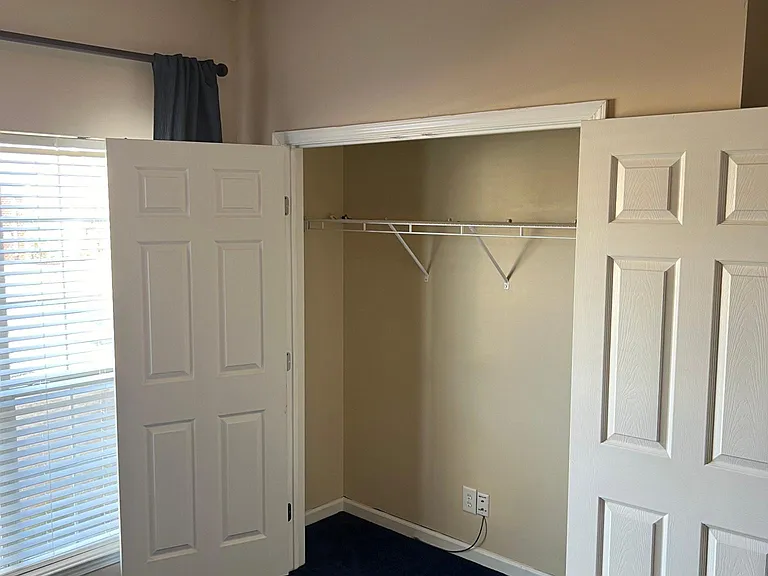 Front bedroom closet with large closet.