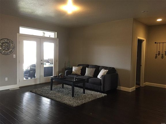 Formal living room with the entryway to the master bedroom to the right.