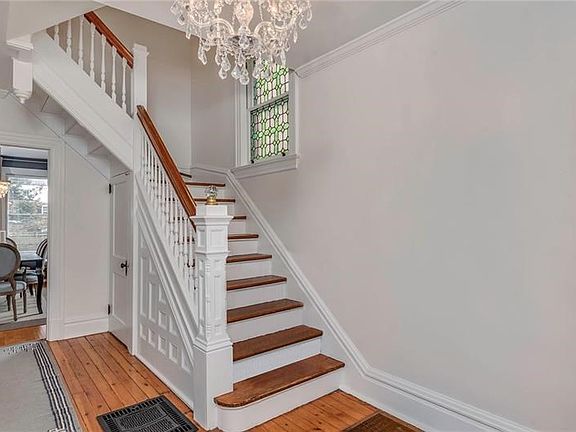 Spacious Foyer to Greet Family and Friends.  Don't Miss the Judges Paneling on the Staircase and the Gorgeous Stained Glass Wind