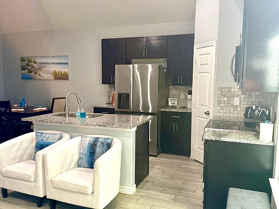 Counter space showing refrigeratoer, and stove and microwave