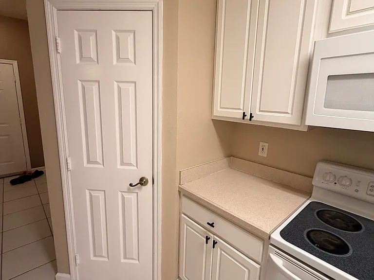 Large pantry behind the door, entry door in the background. Washer and dryer are to the left as you enter the front door.