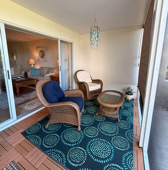 Screened lanai with sitting area overlooking patio and golf course