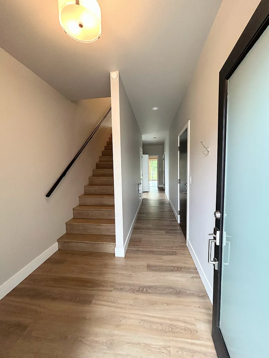 Entrance with stairs to main living. Hallway goes back to the master bedroom. - 1733 Hillcrest Loop #A
