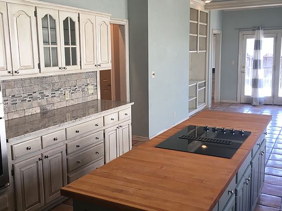 Updated Granite Countertop and Tumbled Marble and Glass Back