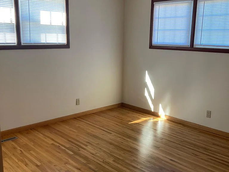 Second bedroom with fresh paint and new window coverings.
