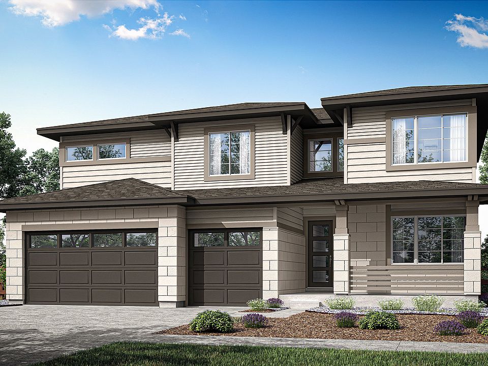 A two-story residential house with a garage, surrounded by trees and landscaping, set against a blue
