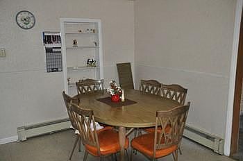 The eating area has a built-in shelf unit to display your favorite items.  Plenty of space for a large table.