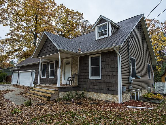 The covered front porch leads you right in. Notice the seamless gutters and egress window.