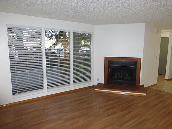 Family room with loads of light and open concept connecting living, dining and kitchen areas.