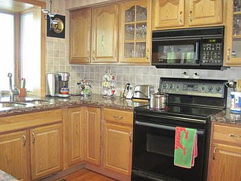 Modern kitchen with appliances granite counter tops and again the focus is on the lake