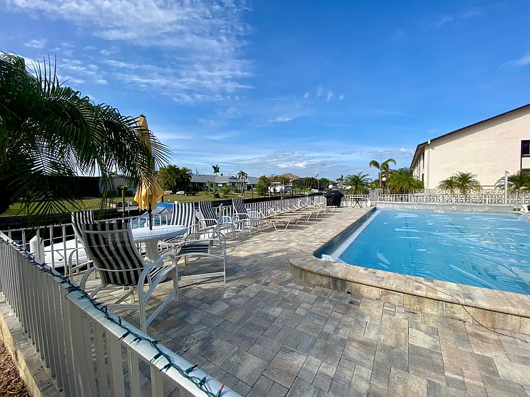 Large paver deck pool area - HEATED pool, lounge chairs and tables and a grill for your use.