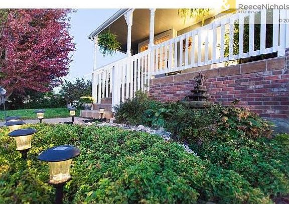 Well manicured lawn and landscape surround the home