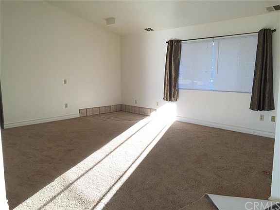 living room with new carpet and room for a wood stove.