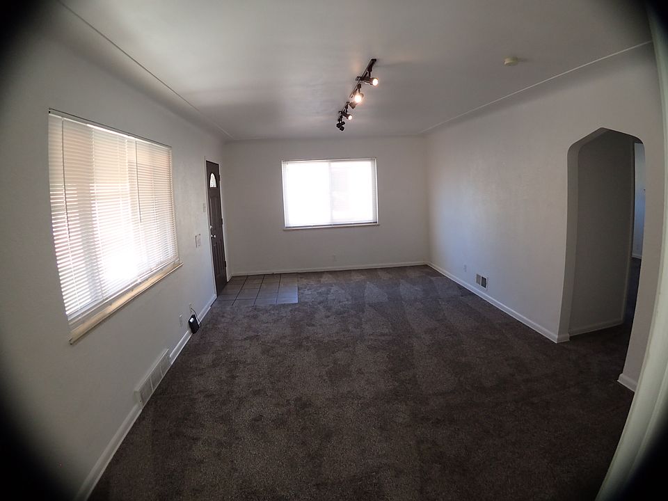 Livingroom with 8 ft of track lighting, coved ceilings, keyhole doorway. TONS of natural light.