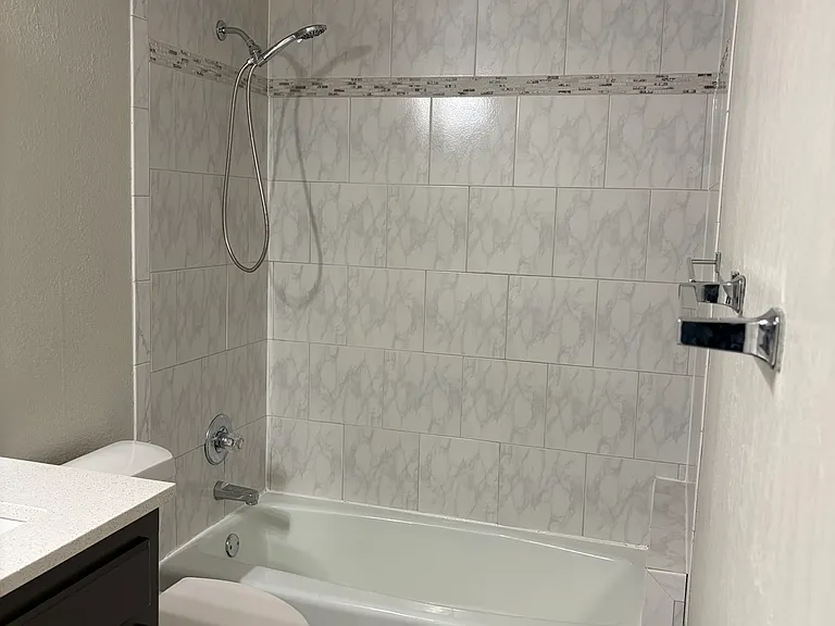 View of upstairs bathroom with toilet and shower/tub.