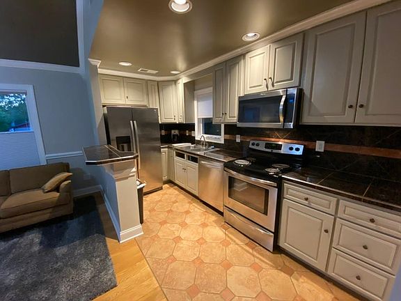 Fully equipped kitchen with stainless steel full-sized appliances, includes toaster oven, coffee maker, crock pot, blender, glassware, dishes, flatware, etc.