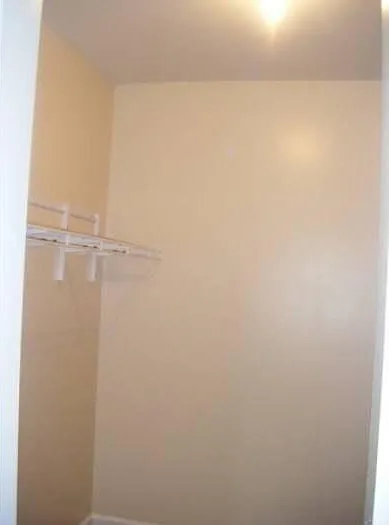 One side of the primary bedroom closet
