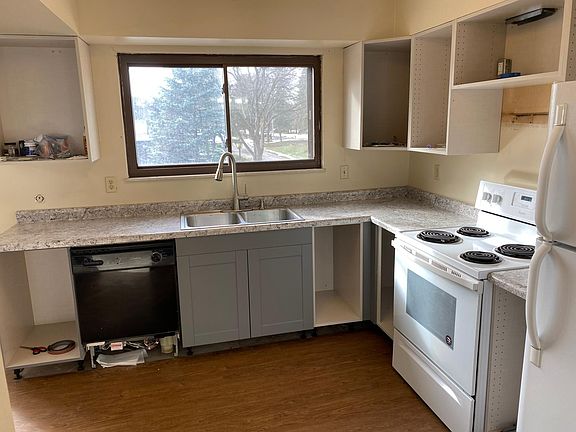 Kitchen cabinets will be done soon. Dishwasher will be replaced with a new white dishwasher and a new microwave will be installed above the stove. New vinyl flooring.