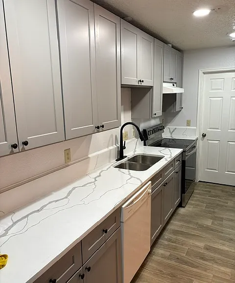 Kitchen with new cabinets, appliances, and new tiled floors