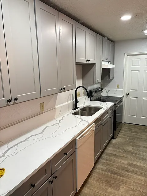 Kitchen with new cabinets, appliances, and new tiled floors - 24107 Broken Bow Ln