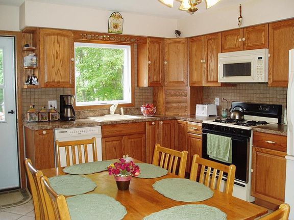 Lt. Oak Cabinets, CT Floor, Door leads to Deck & backyard