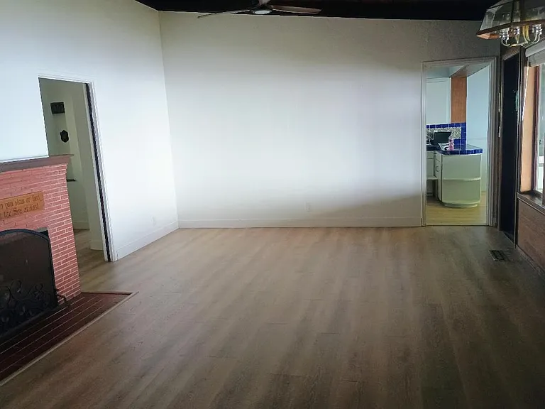 Living Room - Entry Is Located On the Left, Kitchen Upper Right, Back Door To Patio On The Right