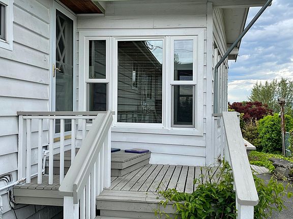 The steps to the front door. The study/office windows and the walk leading to the deck beyond.