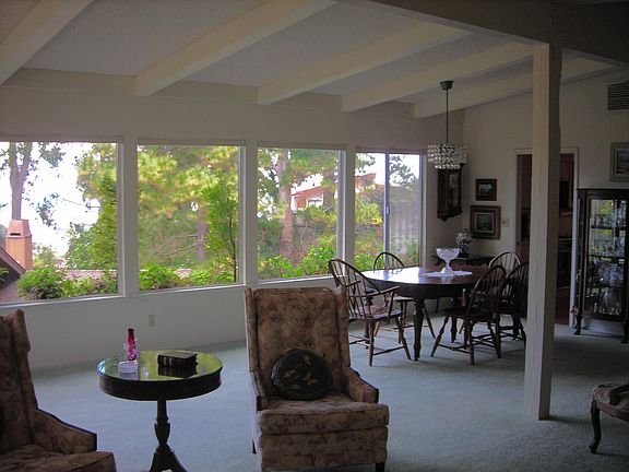 Living/dining room with a wall of windows to enjoy the views