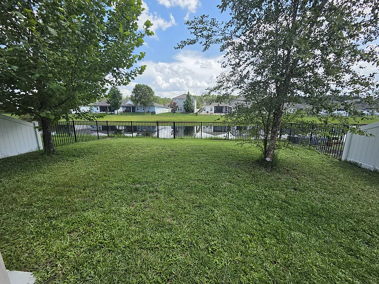 Fully fenced yard w/ privacy pond