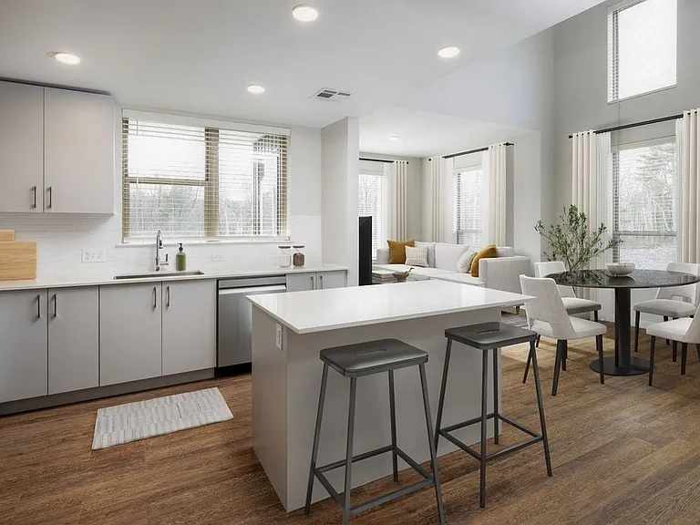 Kitchen with stainless steel appliances, white quartz countertop, light grey cabinetry, and hard surface flooring