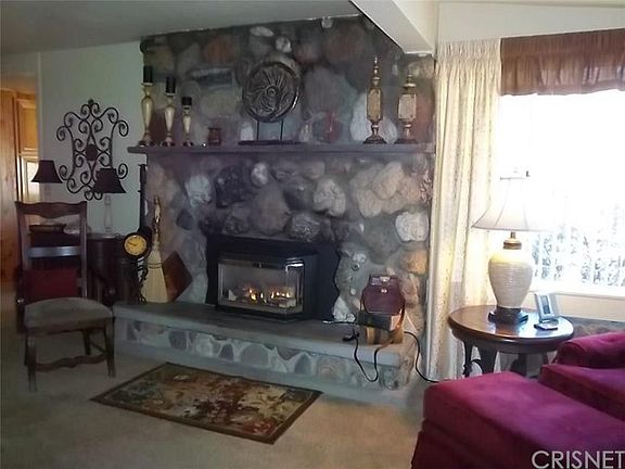 Beautiful rock fireplace with gas insert and blower.