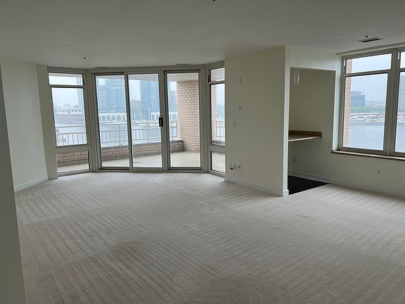 Living room with built in bar/desk next to window.