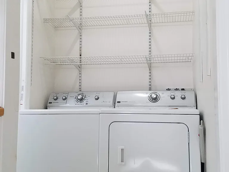 Laundry room with washer and dryer and shelves