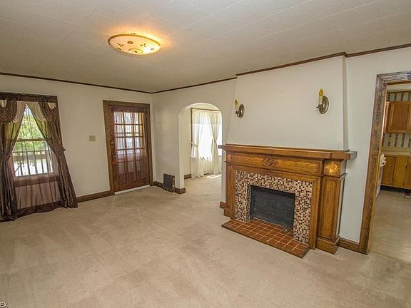 Beautiful tile work and woodwork surrounding the fireplace.