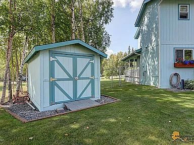 This is the garden shed with two lawnmowers in it for ease of maintaining the yard along with several other tools.