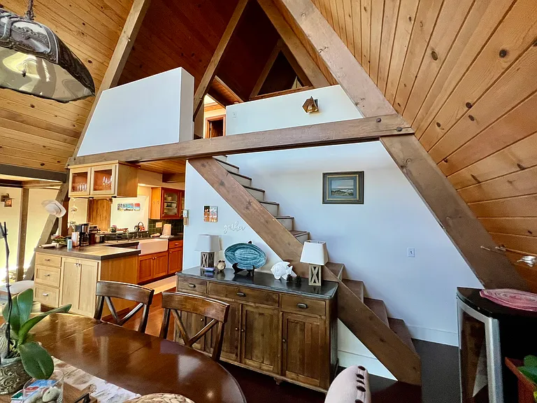 Staircase to loft, with dining room in foreground