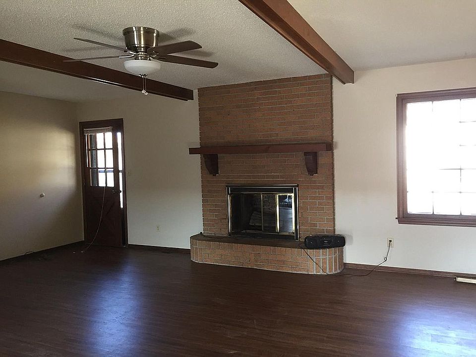 Family room with beams, non wood burning fireplace