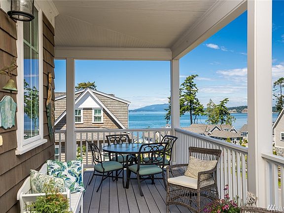 The sheltered front porch will be your favorite place to enjoy the parade of boats through the channel.