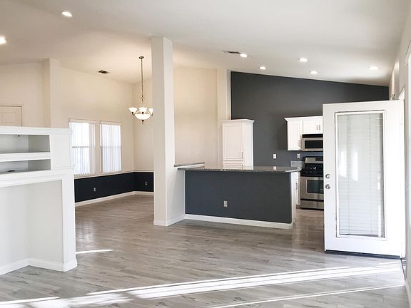 From Living Room area to overlook Kitchen and Dinning areas (Door access to backyard)