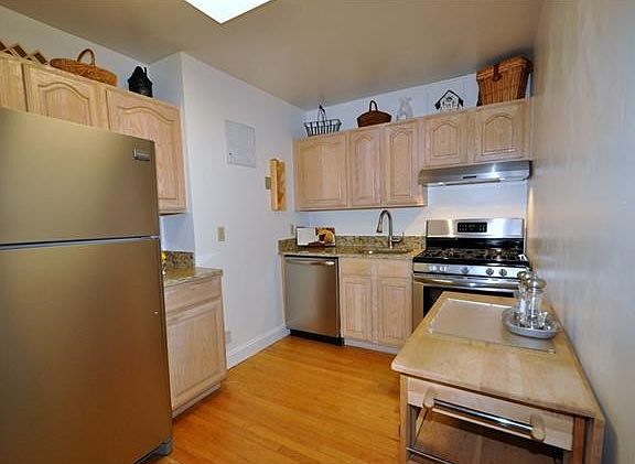 New Eat-in-Kitchen with Granite Counters and Stainless Steel Appliances including a dishwasher, range and refrigerator.