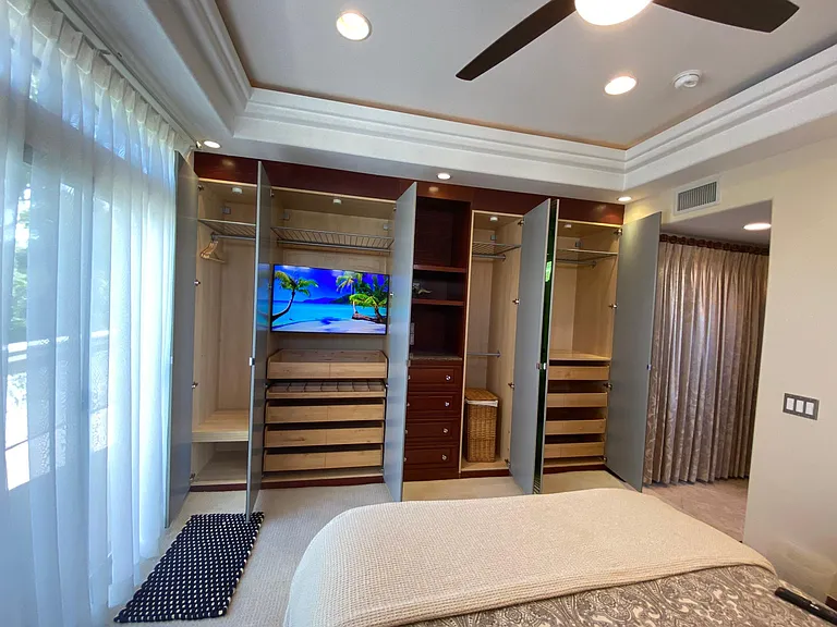 Master double closets with organizers and smart TV