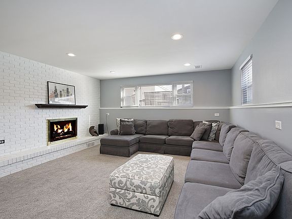 Family room with new carpet & gas fireplace.