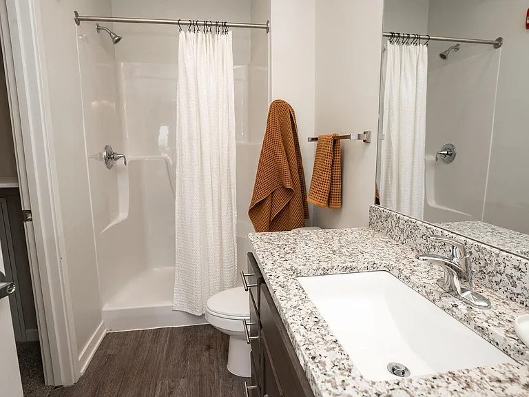 Walk-in shower in a bathroom at Heartland Flats North Platte.