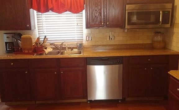 Upgraded kitchen with stainless steel range, microwave and dishwasher.