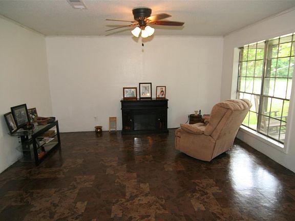 Living room with double window and ceiling fan.  Just waiting for your touch of home!