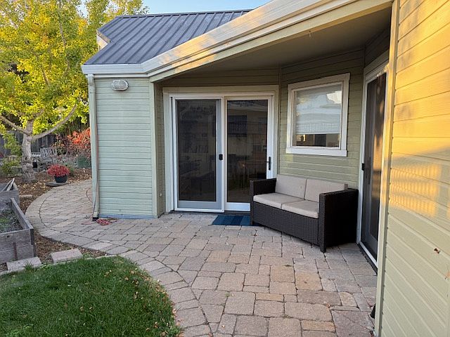 Patio entrance area. Swinging French door entrance to living room and slider to bedroom. Spot is sheltered and often sunny. Great spot to enjoy your morning coffee or tea.