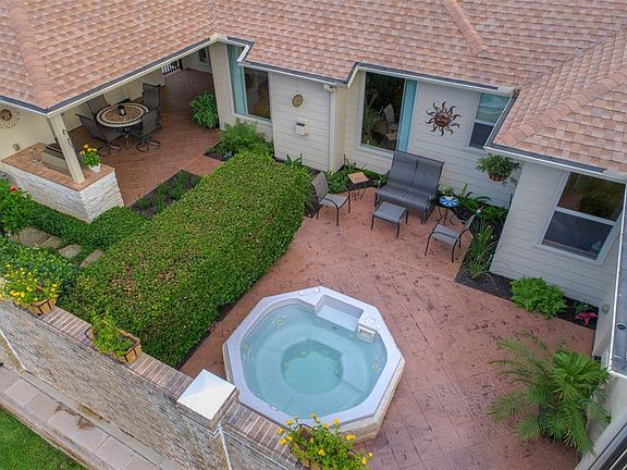 This home features a private courtyard with built-in spa, summer kitchen and water feature.